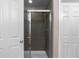 A tiled shower stall with a glass door shows next to a closed white door at 7536 Grady Cir, Castle Rock, CO 80108