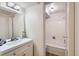 Bathroom with white vanity, tile, and a view into the bathtub area, maximizing space efficiency at 1050 N Lafayette St # 101, Denver, CO 80218