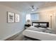 Bedroom with modern decor, including bed, side table, artwork, and ceiling fan at 1050 N Lafayette St # 101, Denver, CO 80218