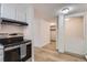 Kitchen with stainless steel appliances and adjacent living space, promoting modern living at 1050 N Lafayette St # 101, Denver, CO 80218