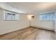 Empty living room with wood-look flooring, bright windows, and ample natural light at 1050 N Lafayette St # 101, Denver, CO 80218