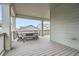 Charming covered back porch with a table and chairs, offering a serene outdoor dining space at 946 Compass Dr, Erie, CO 80516