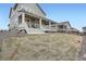 Lush backyard featuring a well-manicured lawn and large covered porch, ideal for entertaining at 946 Compass Dr, Erie, CO 80516