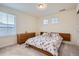 Bright bedroom features a floral comforter, wood accents, and ample natural light at 946 Compass Dr, Erie, CO 80516