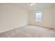 Bright bedroom with carpeted floors and a large window at 946 Compass Dr, Erie, CO 80516