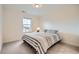 Cozy bedroom featuring carpeted floors and a window with backyard views at 946 Compass Dr, Erie, CO 80516