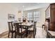 Elegant dining room with a large table, comfortable seating, and stylish decor with hardwood floors at 946 Compass Dr, Erie, CO 80516