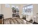Bright home office features a large window, built-in shelving, and hardwood floors for a productive workspace at 946 Compass Dr, Erie, CO 80516