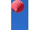 Red hot air balloon floating in a vibrant blue sky, perfect for capturing a dreamy ambiance at 946 Compass Dr, Erie, CO 80516