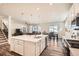 Open concept kitchen with a large island, modern appliances, and seamless flow into the living area at 946 Compass Dr, Erie, CO 80516