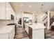 Beautiful kitchen with white cabinets, stainless appliances, quartz countertops, and wood flooring at 946 Compass Dr, Erie, CO 80516