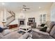 Spacious living room boasts a modern fireplace, staircase, and comfortable seating with an open layout at 946 Compass Dr, Erie, CO 80516