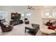Cozy upstairs living room with plush leather seating, large screen TV, and ceiling fan at 946 Compass Dr, Erie, CO 80516