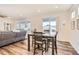 Open living room with plenty of natural light, wood floors, and dining area at 946 Compass Dr, Erie, CO 80516