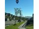 Neighborhood street view featuring a hot air balloon, lined with well-maintained homes and lush landscaping at 946 Compass Dr, Erie, CO 80516