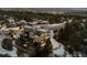 Panoramic view of beautiful modern home in wooded location with city lights visible in the distance at 1803 Avenida Del Sol, Castle Rock, CO 80104