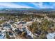 Aerial shot of house in a mountain neighborhood with snow on the ground and blue sky at 1803 Avenida Del Sol, Castle Rock, CO 80104