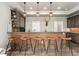 Home bar with seating, custom wood cabinetry, sink and tile backsplash, perfect for entertaining at 1803 Avenida Del Sol, Castle Rock, CO 80104