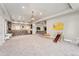 Open basement living space, perfect for entertaining, with bar, TV area, and access to outdoors at 1803 Avenida Del Sol, Castle Rock, CO 80104
