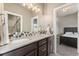 Bathroom featuring double sinks, dark wood cabinets, and decorative tile backsplash at 1803 Avenida Del Sol, Castle Rock, CO 80104