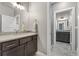 Clean and bright bathroom featuring double vanity, tile backsplash, tile floor, and walk-in shower with glass door at 1803 Avenida Del Sol, Castle Rock, CO 80104