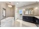 Bright bathroom with a standalone tub, vanity, and tiled shower with glass doors at 1803 Avenida Del Sol, Castle Rock, CO 80104