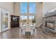 Bright dining room with a stone fireplace and large windows with scenic views at 1803 Avenida Del Sol, Castle Rock, CO 80104
