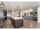 Modern kitchen featuring stainless steel appliances, a large island, and an open floor plan into the living area at 1803 Avenida Del Sol, Castle Rock, CO 80104