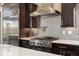 Well-equipped kitchen with stainless steel appliances and stylish gray backsplash at 1803 Avenida Del Sol, Castle Rock, CO 80104