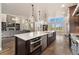 Gourmet kitchen with stainless steel appliances, large island, and pendant lighting at 1803 Avenida Del Sol, Castle Rock, CO 80104
