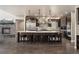 Well-appointed kitchen featuring a large island, stainless steel appliances, and dark wood cabinets at 1803 Avenida Del Sol, Castle Rock, CO 80104