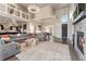 A large living room with high ceilings, a stone fireplace, and elegant furnishings for comfortable living at 1803 Avenida Del Sol, Castle Rock, CO 80104