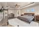 Spacious main bedroom with a ceiling fan, modern furniture, and dark hardwood floors at 1803 Avenida Del Sol, Castle Rock, CO 80104