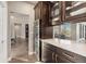 Entertainer's wet bar with a built-in wine fridge, ample storage, and marble countertops at 1803 Avenida Del Sol, Castle Rock, CO 80104