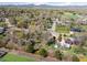Scenic aerial view showcasing the neighborhood, mature trees, and mountain views in the distance at 1542 Kilkenny St, Boulder, CO 80303