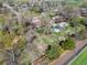 Aerial view of a large backyard with garden beds, mature trees, and storage sheds in a neighborhood setting at 1542 Kilkenny St, Boulder, CO 80303