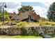 Inviting entrance to Atlas Valley with a rock waterfall feature and lush landscaping at 1542 Kilkenny St, Boulder, CO 80303