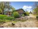 Charming home showcasing unique exterior details, a fenced yard, and lush greenery at 1542 Kilkenny St, Boulder, CO 80303
