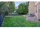 Well-maintained backyard with lush green grass, mature trees, and a fenced perimeter for privacy at 5683 Fig Way, Arvada, CO 80002