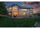 Outdoor living space featuring a patio, grill, and well-maintained lawn with a fenced yard at 5683 Fig Way, Arvada, CO 80002