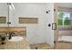 Modern bathroom with a walk-in shower, stone tiling, and a garden tub at 5683 Fig Way, Arvada, CO 80002