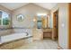 Bright bathroom with a garden tub, light wood vanity, and stylish finishes at 5683 Fig Way, Arvada, CO 80002
