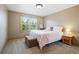 Relaxing bedroom with a window view, plush bedding, and a cozy atmosphere at 5683 Fig Way, Arvada, CO 80002