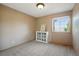 Cozy bedroom with neutral walls, plush carpet, and natural light from the window at 5683 Fig Way, Arvada, CO 80002