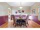 Bright dining room perfect for gatherings, boasting a stylish chandelier and hardwood floors at 5683 Fig Way, Arvada, CO 80002