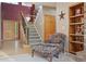 Inviting entryway with hardwood floors, staircase, and natural light pouring in from the front door at 5683 Fig Way, Arvada, CO 80002