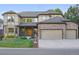 Beautiful brick and stucco home with a well-kept lawn and attached two-car garage at 5683 Fig Way, Arvada, CO 80002