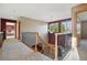 Second-floor hallway with staircase featuring an ornate railing, and views to bedroom at 5683 Fig Way, Arvada, CO 80002