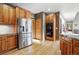 Modern kitchen featuring stainless steel appliances, granite countertops, and wood cabinets with plenty of storage at 5683 Fig Way, Arvada, CO 80002