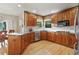 Bright kitchen with granite countertops, stainless steel appliances, tile backsplash, and wood cabinets at 5683 Fig Way, Arvada, CO 80002